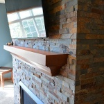 brick fireplace with a tv mounted on it