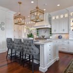a remodeled kitchen with white cabinets