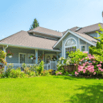 house front yard with flowers and trees